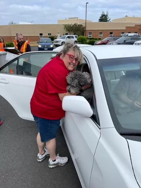 Branch manager Nicole giving a furry friend some love during one of our Shred Day events.